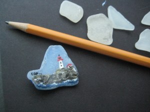 Glass painted with a lighthouse scene and glazed, then made in to a pin